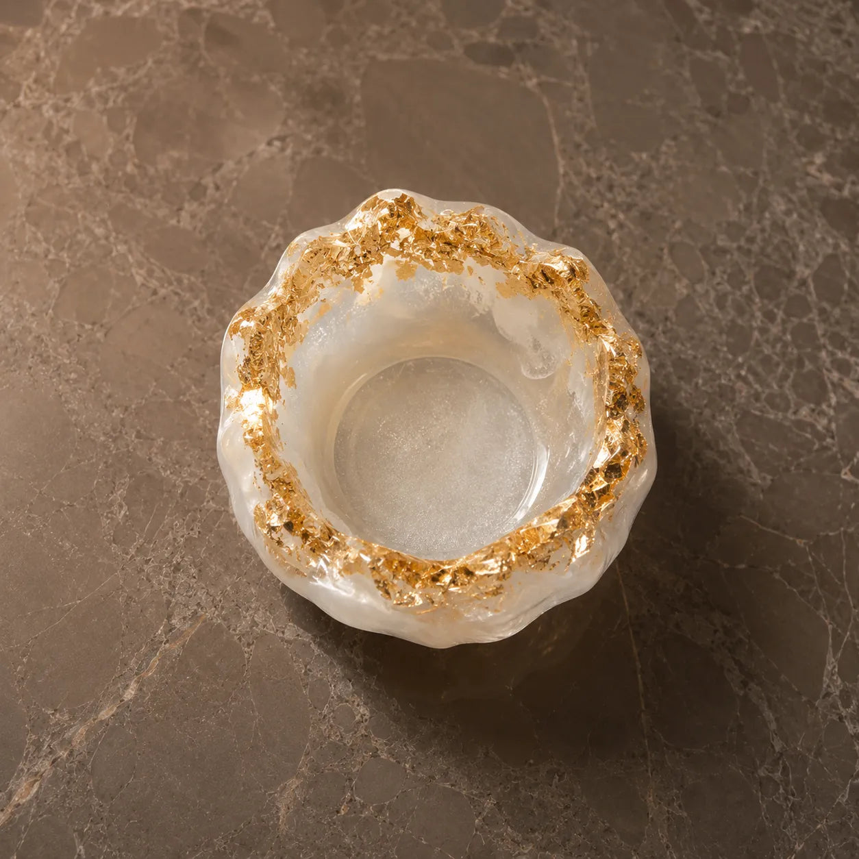 Decorative ring with gold edge on a marble surface