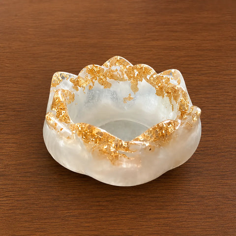 Decorative White & Gold Resin Diya Holder on a wooden surface
