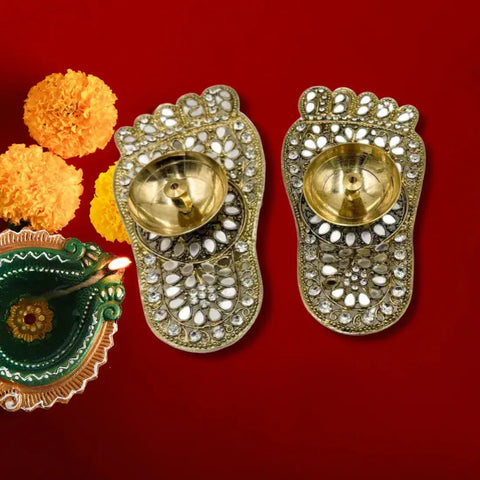 Decorative gold sandals with crystal embellishments on a red background