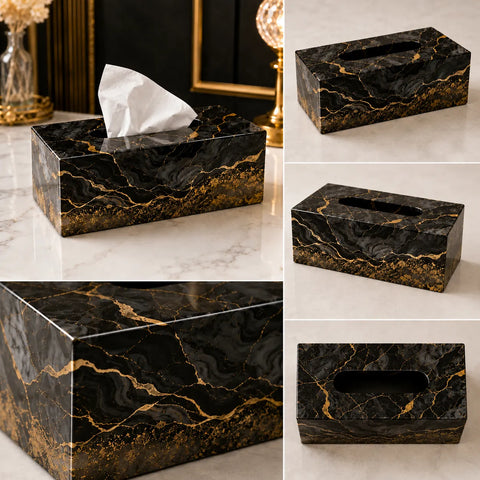 Black marble tissue box with gold veins on a marble surface.