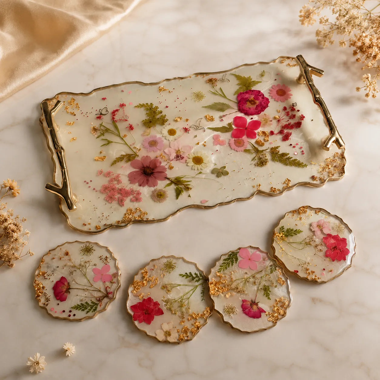 Decorative tray and coasters with floral design on a marble surface