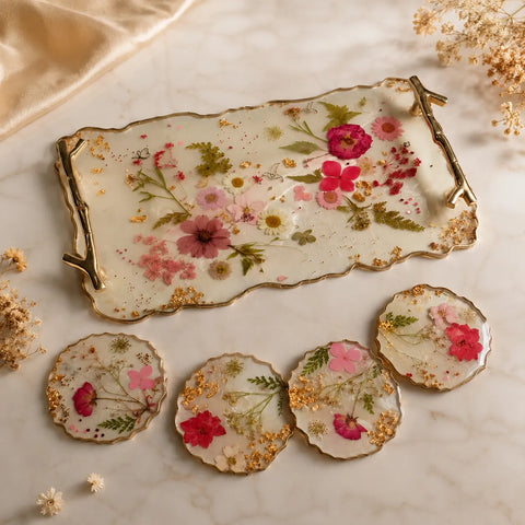 Decorative tray and coasters with floral design on a marble surface
