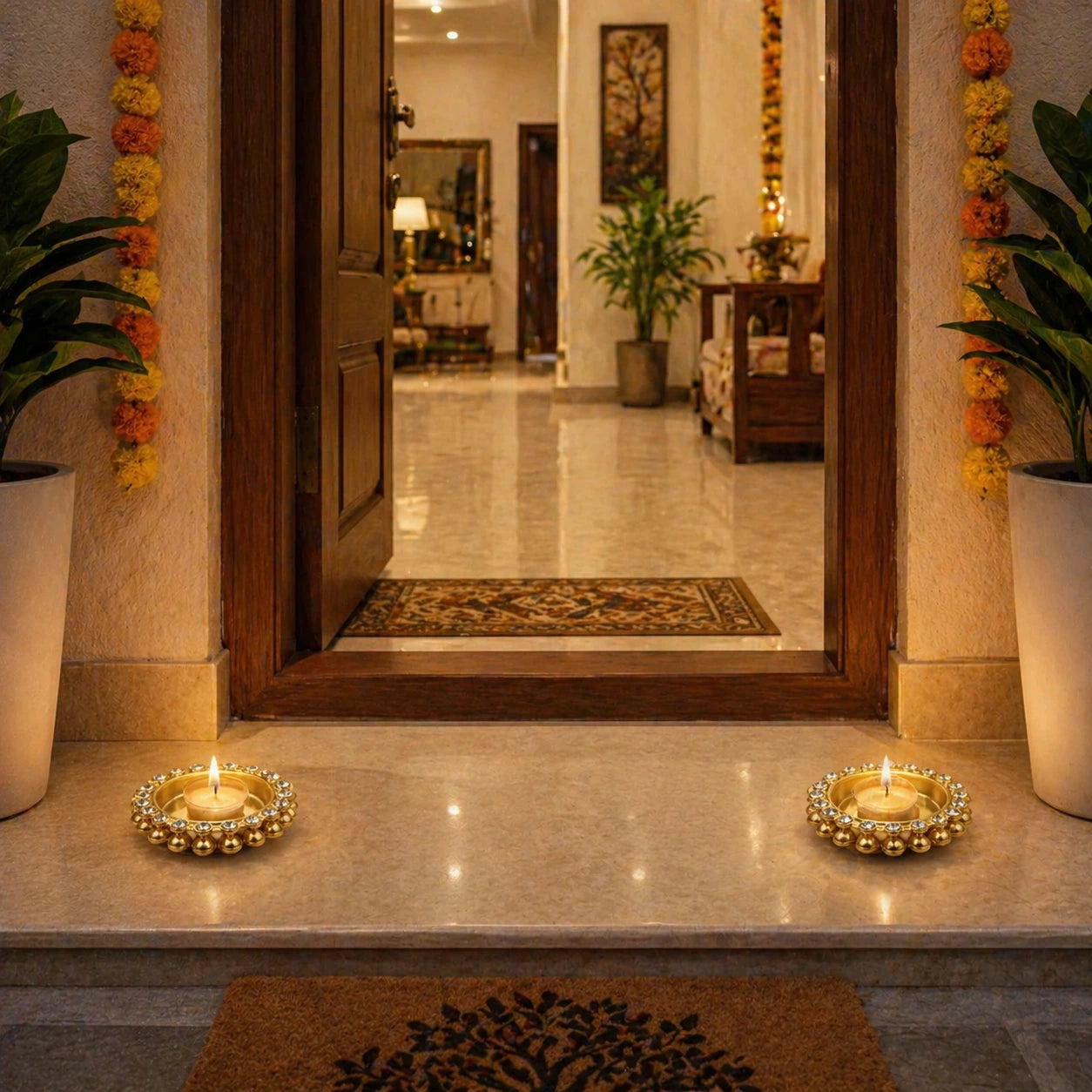 Decorative entrance with candles on a marble surface, plants, and a mirror.