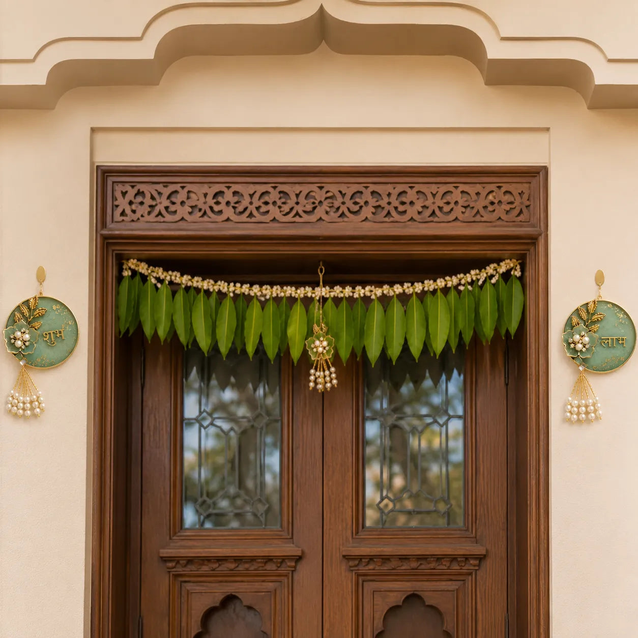 Decorative green leaf garland hanging above a wooden door with intricate carvings.