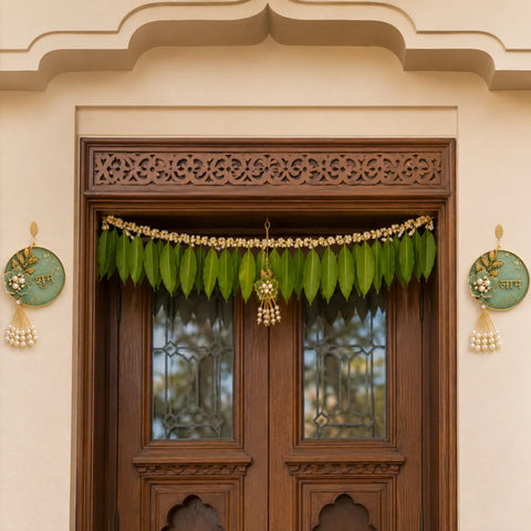 Decorative green leaf garland hanging above a wooden door with intricate carvings.