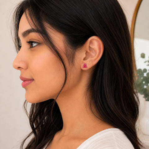 Close-up of a woman wearing pink earrings with a blurred background