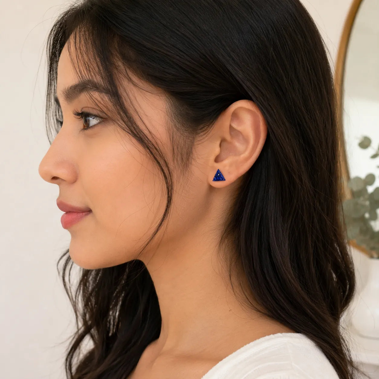 Woman wearing a blue triangular earring, side view