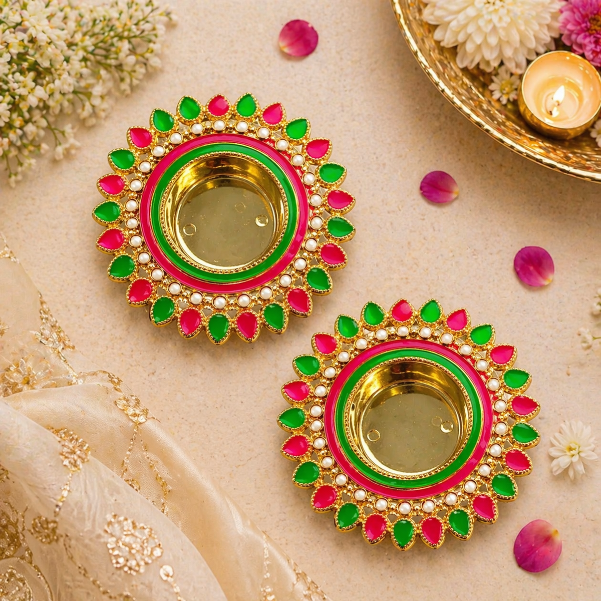 Decorative Diwali oil lamps with pink and green details on a light background.
