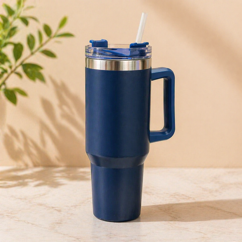 Navy blue stainless steel insulated tumbler with handle and straw, 1200ml large capacity travel mug for hot and cold drinks on marble surface