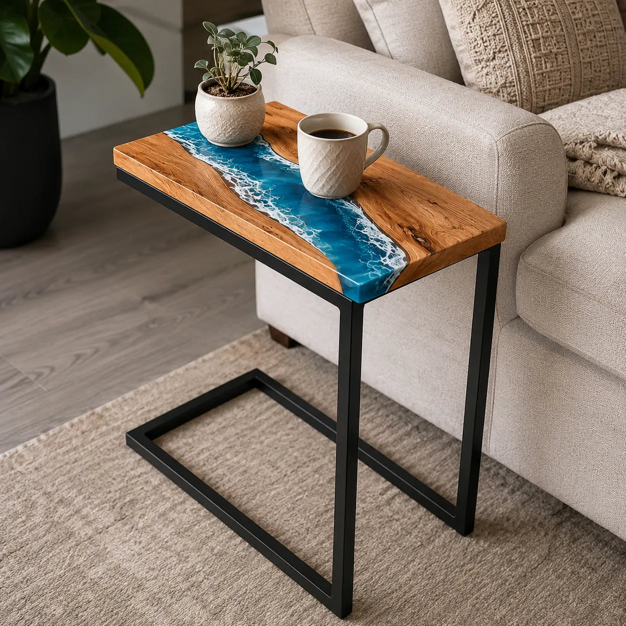 Small wooden table with a blue resin top next to a beige sofa in a living room.