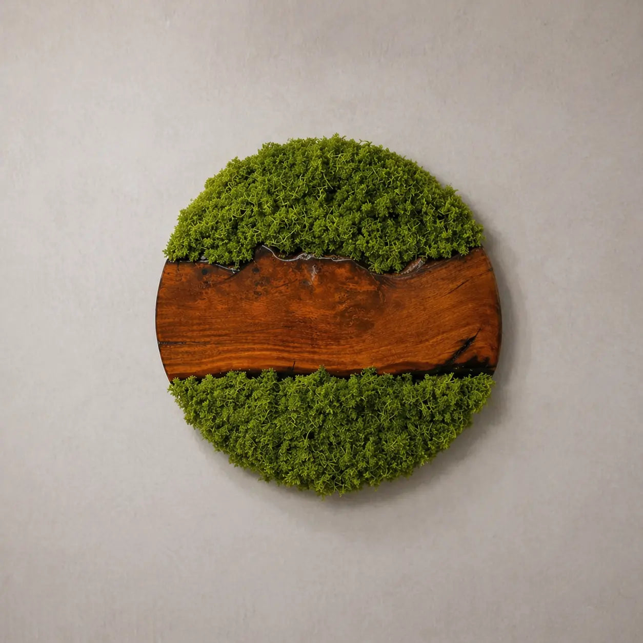 Round wall art piece with green moss and a wooden base on a gray background