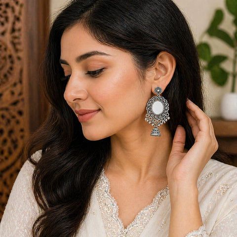 Woman wearing a decorative earring, with a focus on the jewelry.