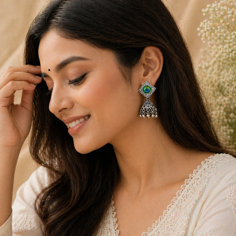 Woman wearing a decorative earring with a blurred floral background