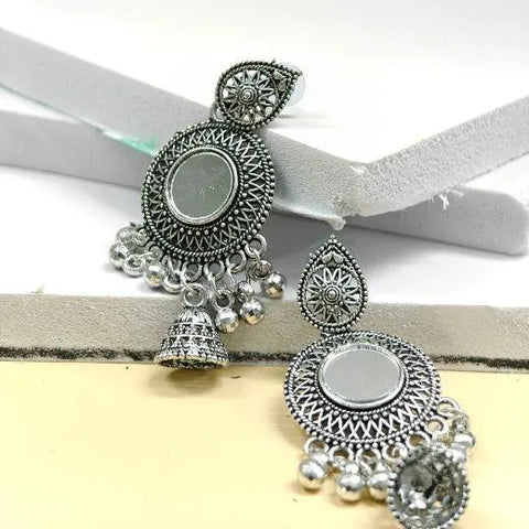 Pair of silver earrings with intricate designs on a white background