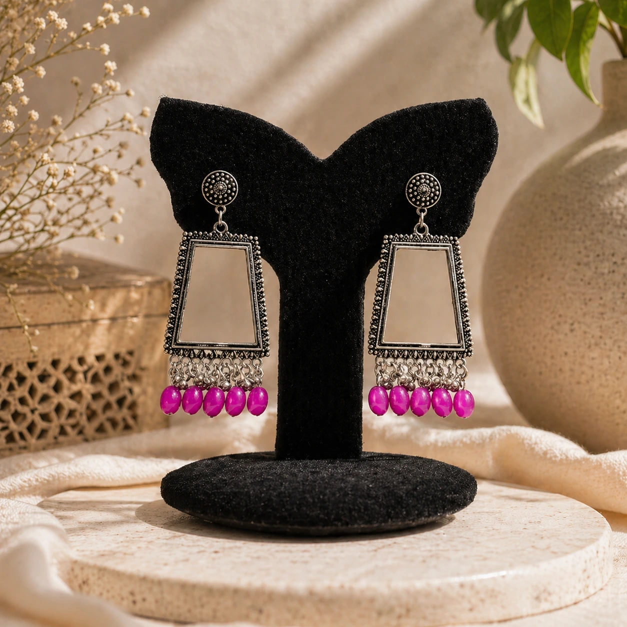 oxidised silver trapezium shape mirror drop earrings with pink beads displayed on black stand premium jewellery image