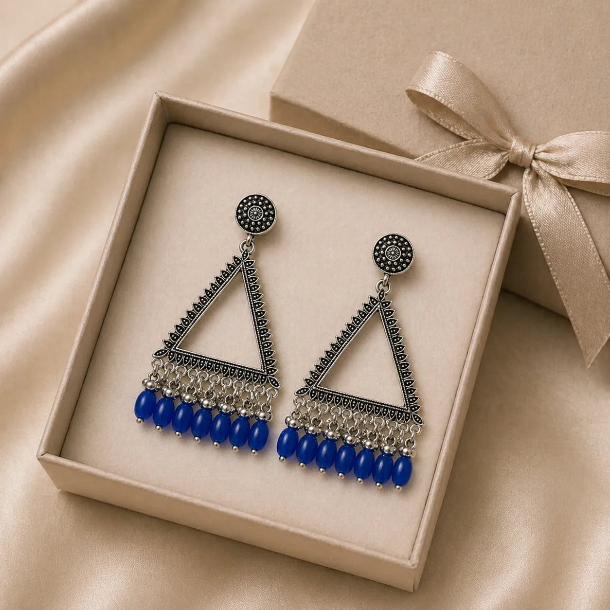oxidised silver triangle drop earrings with blue beads in gift box jewellery packaging image