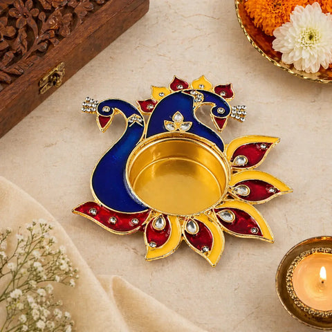 Decorative Diwali oil lamp with peacock design on a light background