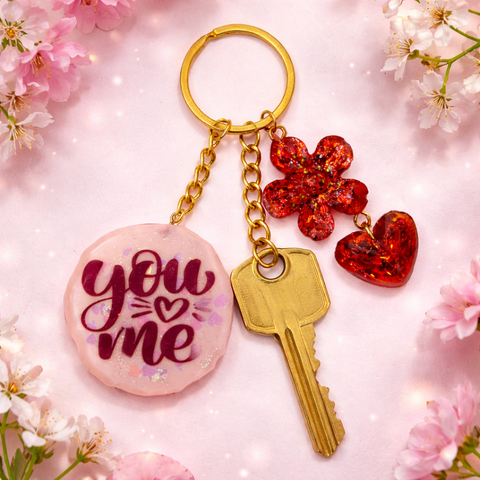 Personalized pink resin keychain with you and me text and red charms