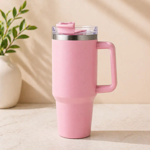 Baby pink stainless steel insulated tumbler with handle and straw, 1200ml large capacity travel mug for hot and cold drinks on marble surface