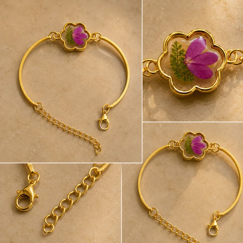 Gold bracelet with a floral clasp on a beige background