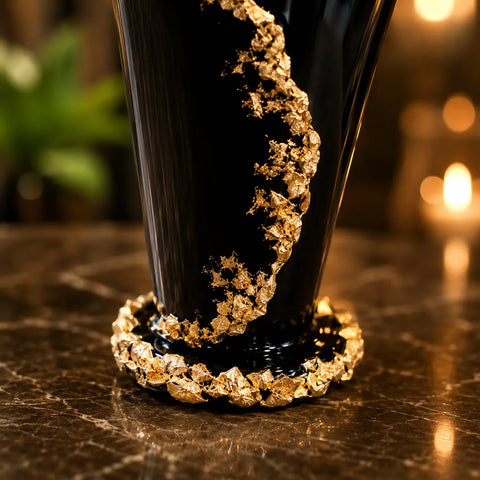 Black glass with gold decorative rim on a textured surface