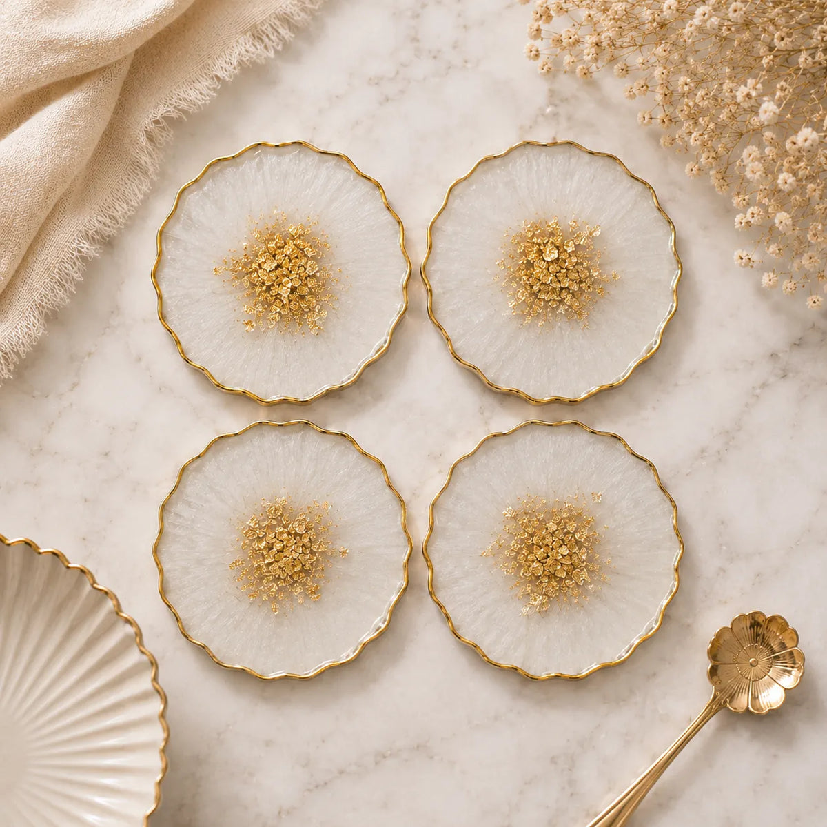 Decorative plates with gold accents on a marble surface with a gold spoon.
