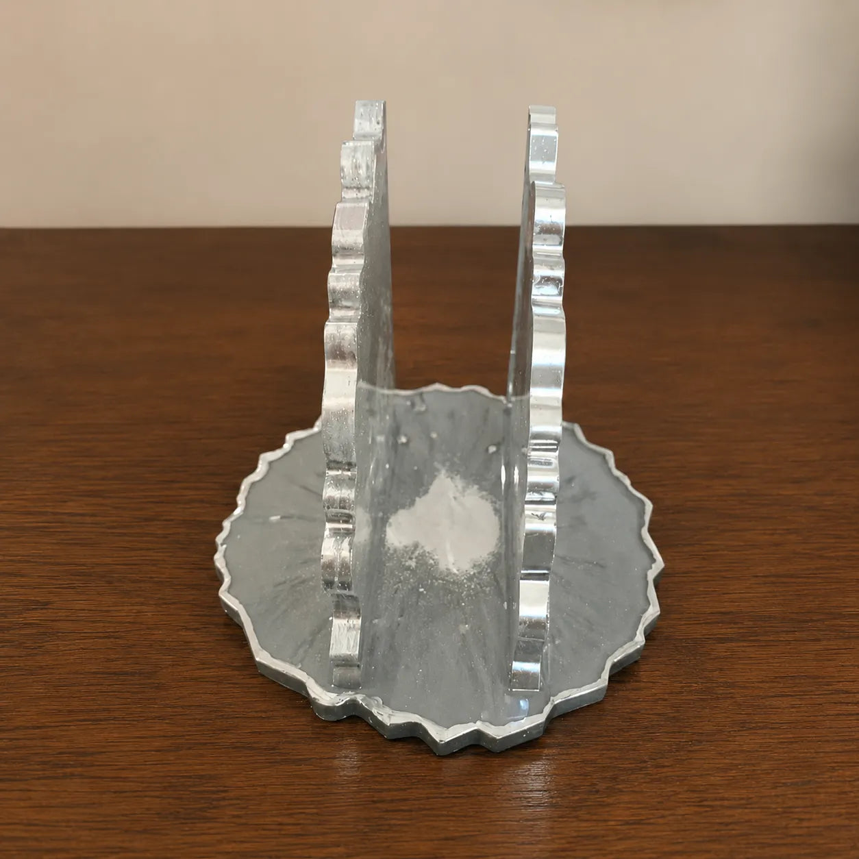 Decorative silver object on a wooden surface