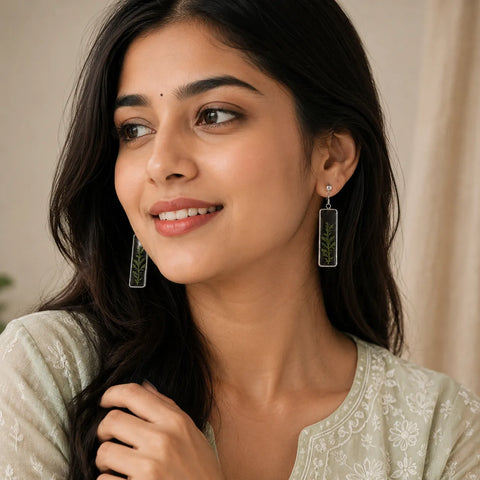 Woman wearing earrings with a neutral background