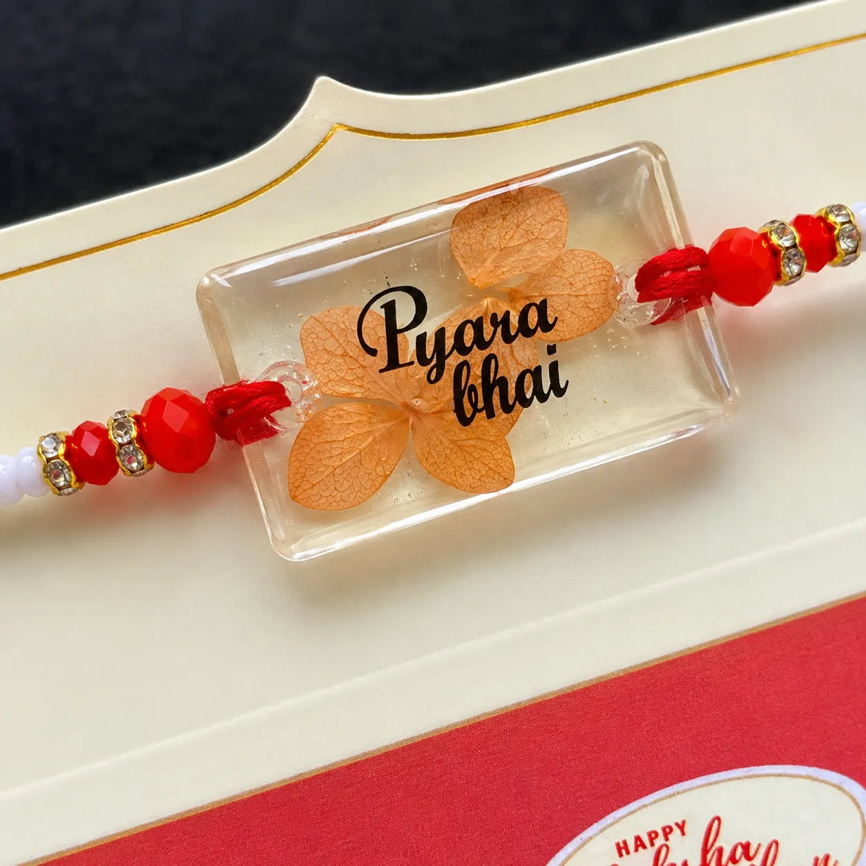 Rakhi with 'Pyara bhai' on a decorative card