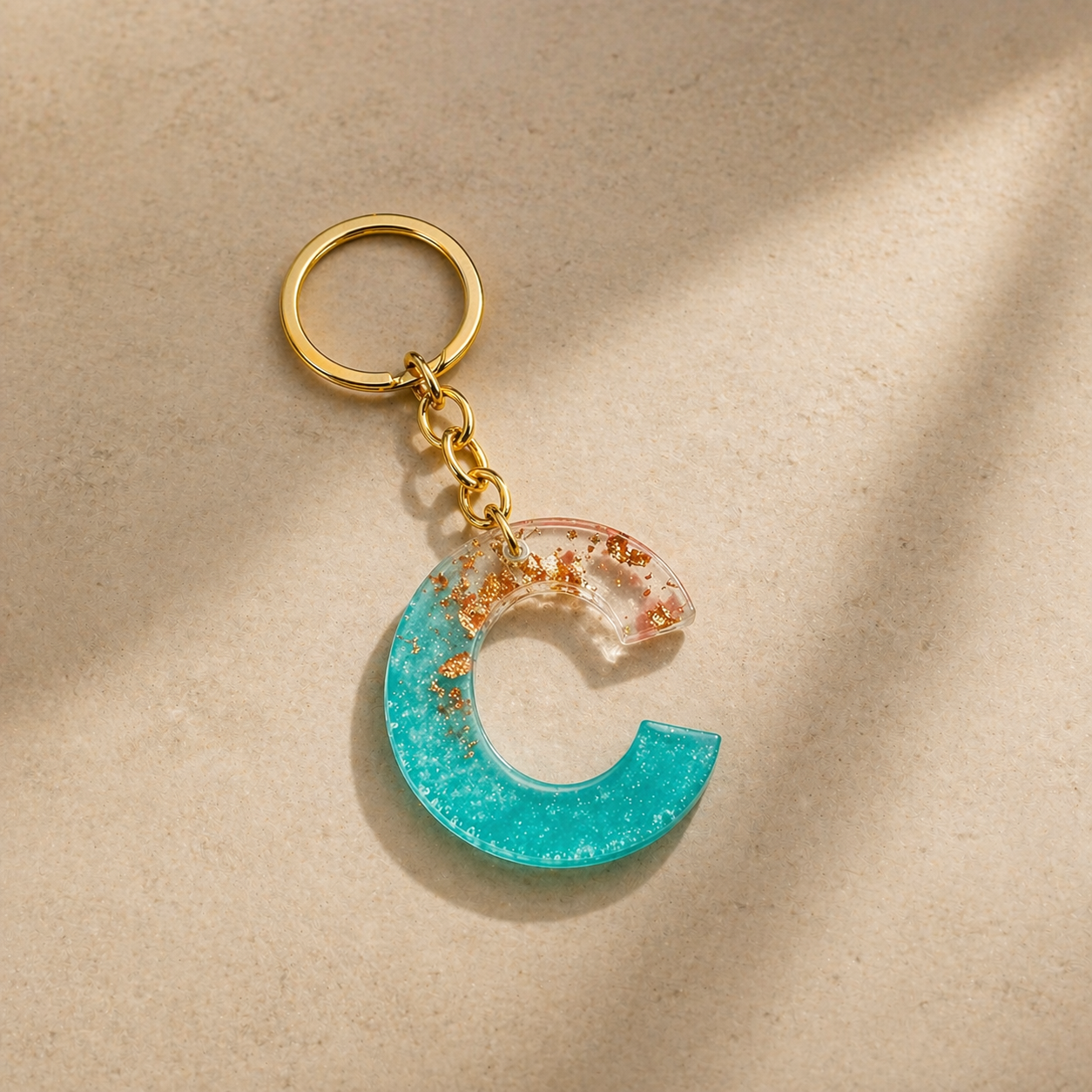 Keychain with a blue crescent moon design on a beige background