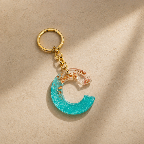Keychain with a blue crescent moon design on a beige background