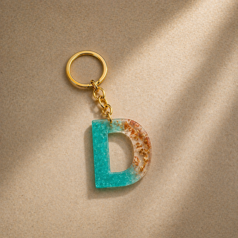Keychain with a letter 'D' design on a beige background