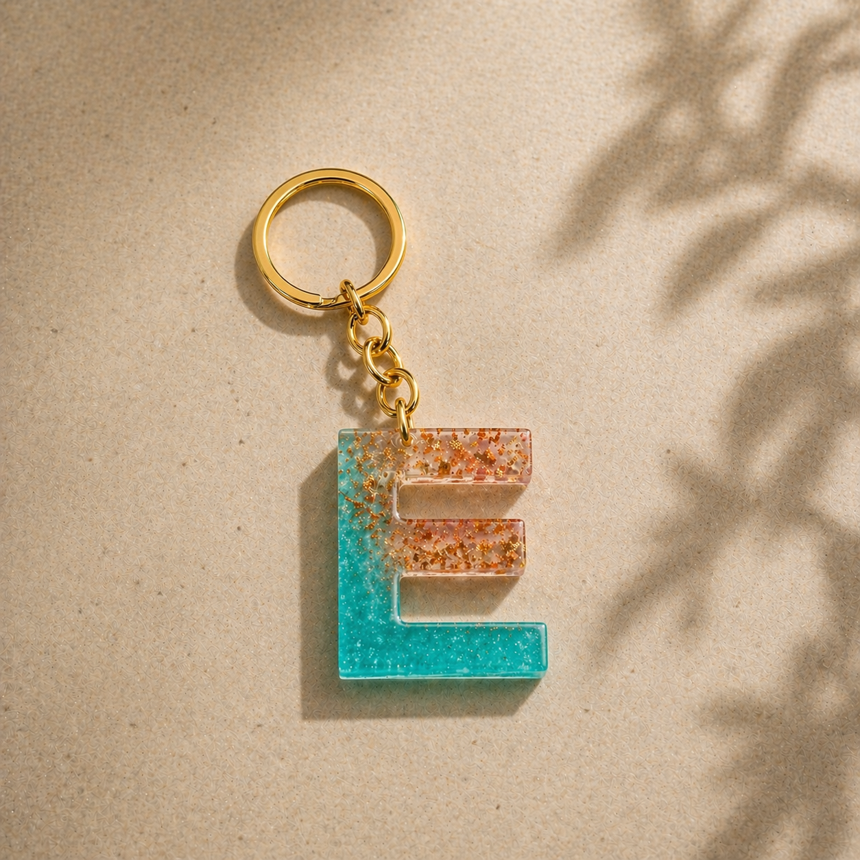Keychain with letter 'E' design on a beige background
