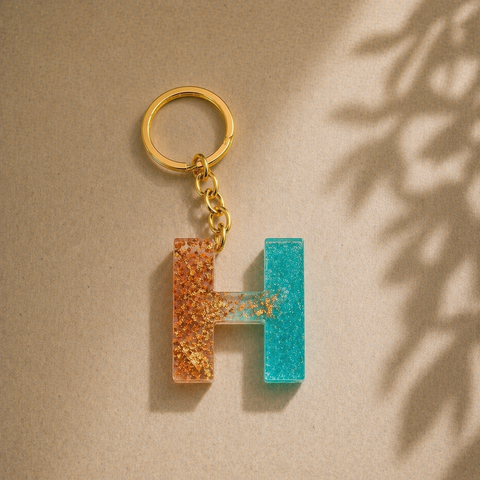 Keychain with a letter 'H' design on a beige background