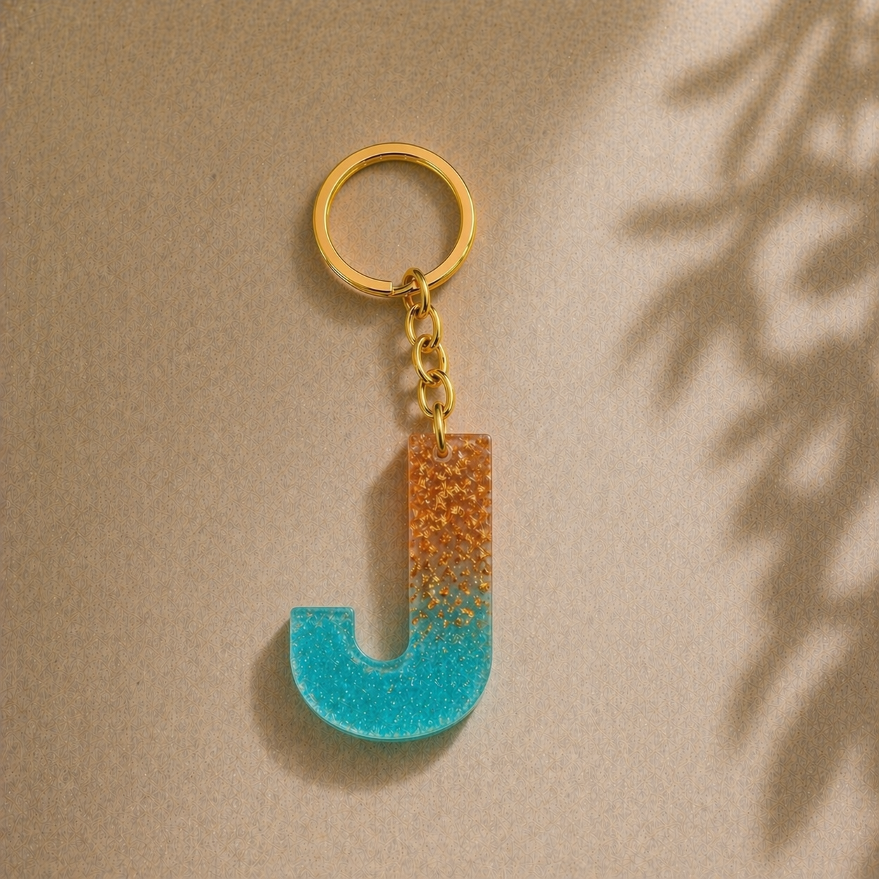 Keychain with a letter 'J' design on a beige background