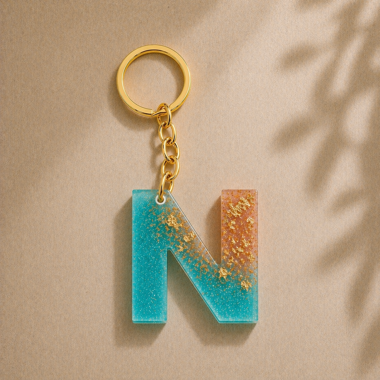 Keychain with a blue and gold letter 'N' on a beige background