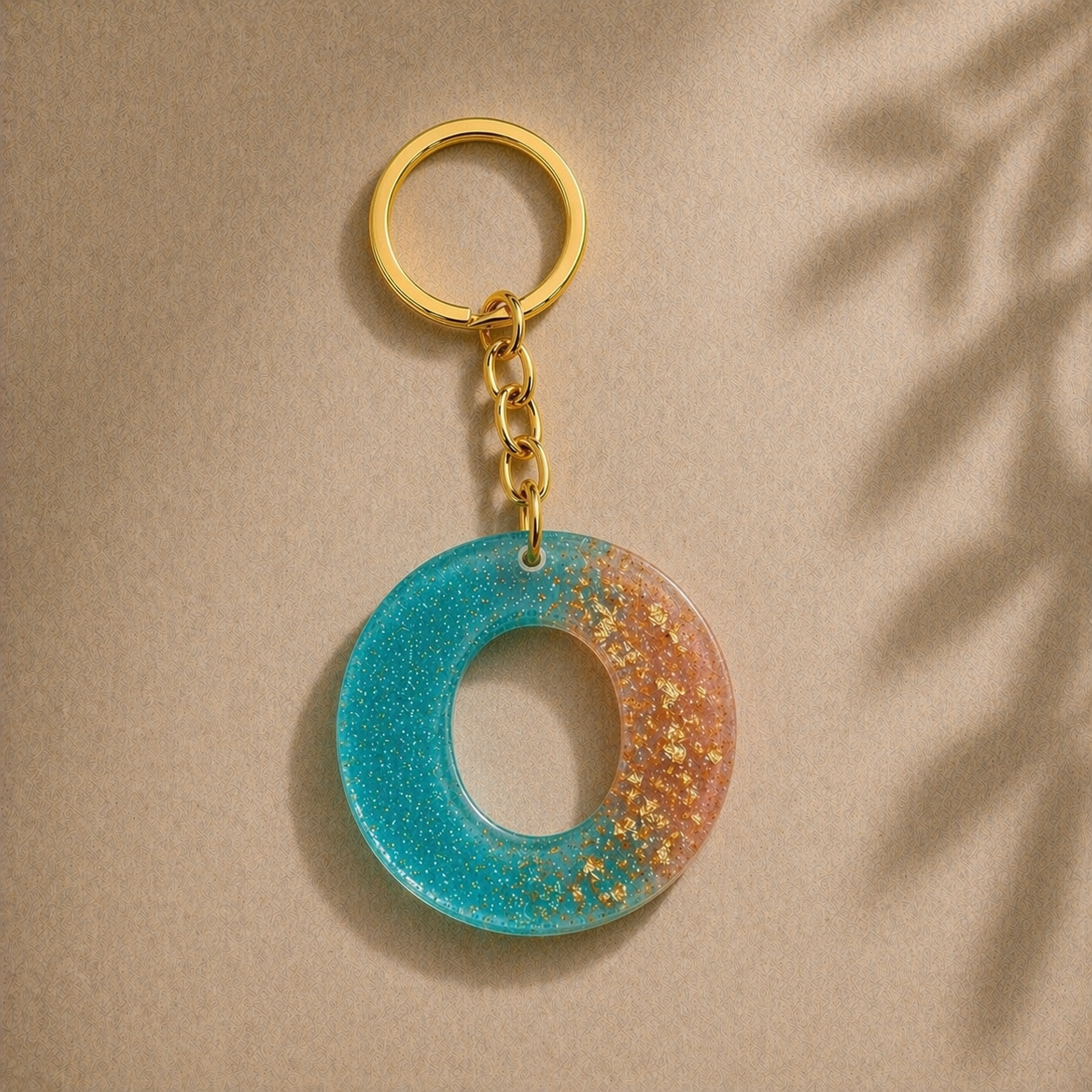 Keychain with a blue and orange circular design on a beige background