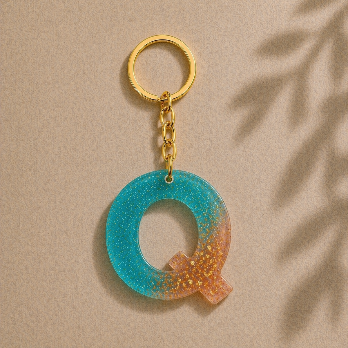 Keychain with letter 'Q' design on a beige background