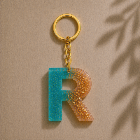 Keychain with letter 'R' in blue and orange gradient on a beige background