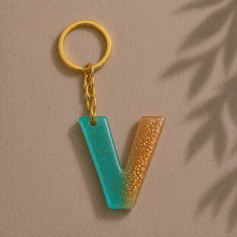 Keychain with a textured 'V' shape on a beige background