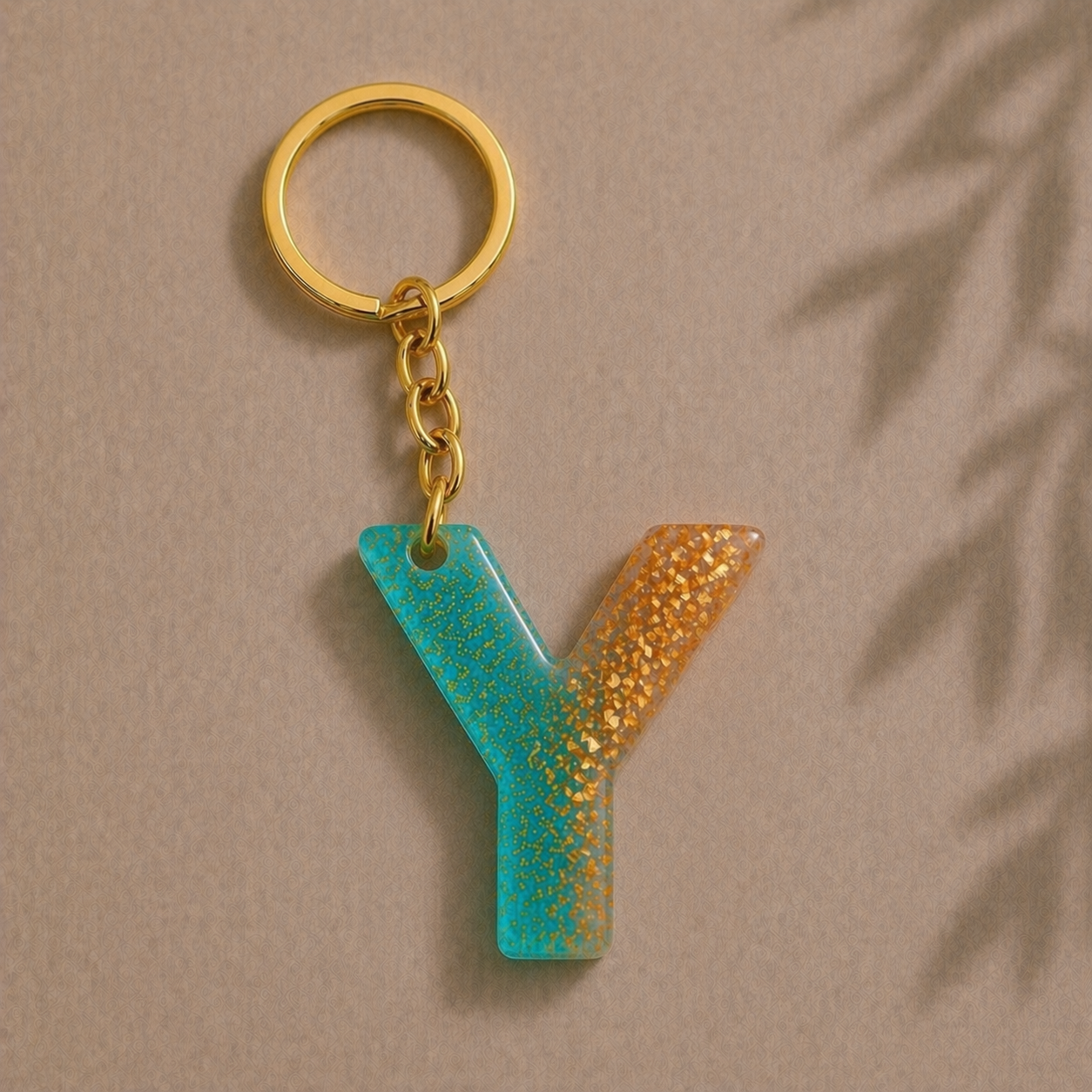 Keychain with a letter 'Y' in blue and gold on a beige background
