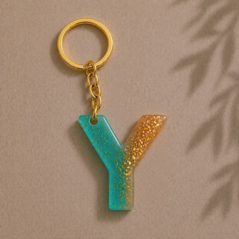 Keychain with a letter 'Y' in blue and gold on a beige background