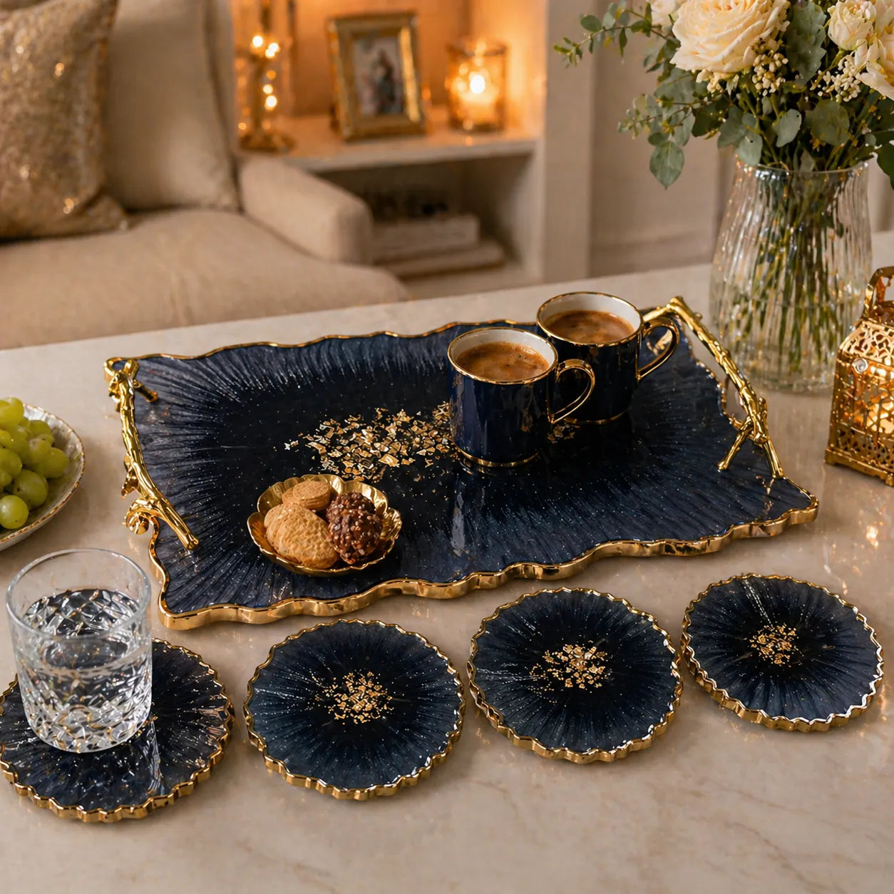 dark blue resin serving tray with gold handles and 4 geode coasters in use with tea cups luxury table decor