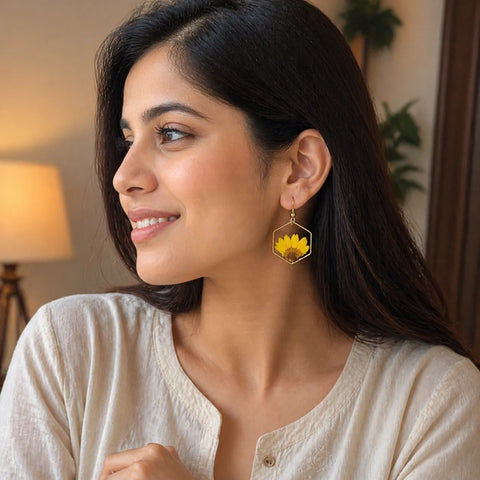 Woman wearing a sunflower earring indoors