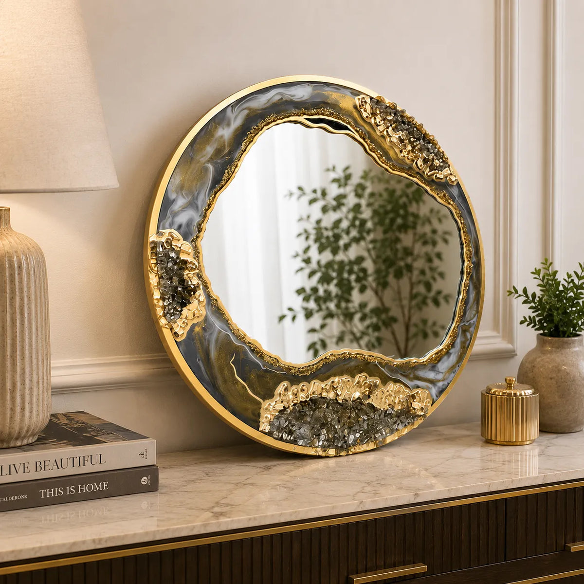 Decorative round mirror with gold frame on a shelf in a home setting