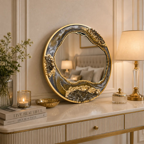 Decorative round mirror with gold frame on a marble surface in a stylish room.