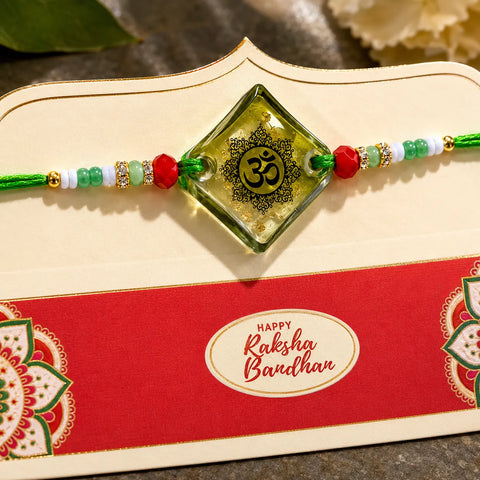 Decorative Rakhi with Om symbol on a 'Happy Raksha Bandhan' card