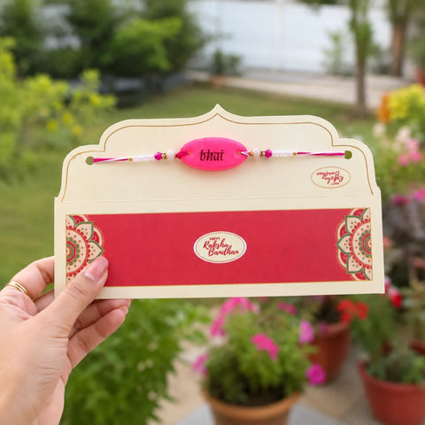 Card with a rakhi (thread bracelet) held by a hand, with a garden background